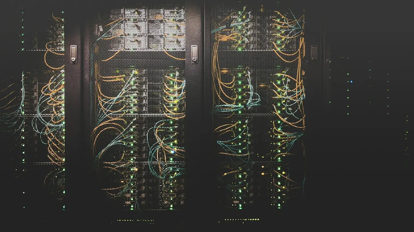 Rows of illuminated equipment racks in a data centre